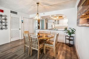 a kitchen and dining room with a table and chairs at Sand Castle 2901 in Clearwater Beach