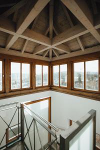 an attic room with wooden ceilings and windows at Hotel "Alter Pfarrhof" in Nabburg