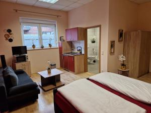 a bedroom with a bed and a living room at Gästehaus Zur Post Spickermann in Xanten