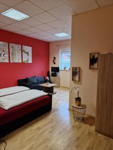 a living room with a bed and a couch at Gästehaus Zur Post Spickermann in Xanten