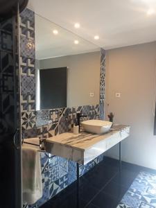 a bathroom with a sink and a mirror at Douro porto apartamento in Valbom