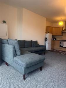 a living room with a couch and a chair at City centre apartment in Sunderland