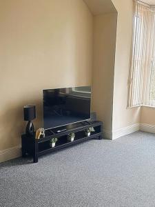 a living room with a large flat screen tv at City centre apartment in Sunderland