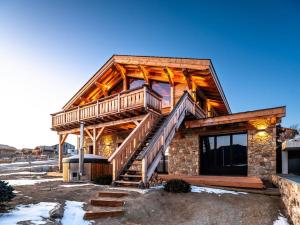 a log cabin with a staircase in front of it at Chalet haut de gamme Bolquère * L'échappée Belle * in Bolquere Pyrenees 2000