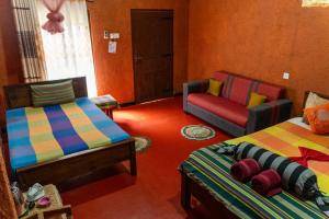 uma sala de estar com duas camas e um sofá em Hotel Hideaway Garage em Dambulla