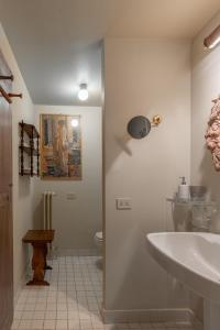 a bathroom with a sink and a toilet at Old Bridge large and unique artful apartment with elevator in Florence