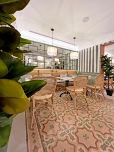 a lobby with chairs and a table in a building at Soho Boutique Turia in Valencia