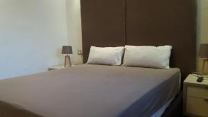 a bedroom with a white bed with two pillows at Bright 2 Bedroom House with Great Front View, Casablanca in Casablanca