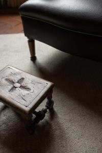 a wooden coffee table sitting next to a chair at Old Bridge large and unique artful apartment with elevator in Florence