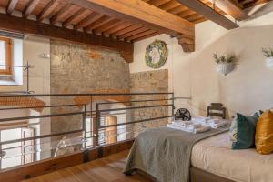 a bedroom with a bed in a room with a balcony at Old Bridge large and unique artful apartment with elevator in Florence