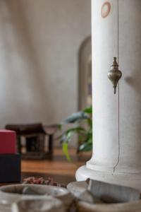 a close up of a white pillar with a bell on it at Old Bridge large and unique artful apartment with elevator in Florence
