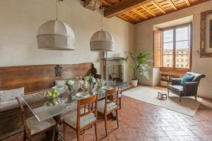 a dining room with a table and chairs at Old Bridge large and unique artful apartment with elevator in Florence