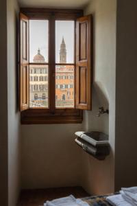 a window in a room with a view of a building at Old Bridge large and unique artful apartment with elevator in Florence