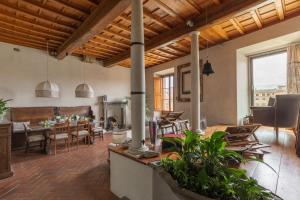 a large living room with a table and chairs at Old Bridge large and unique artful apartment with elevator in Florence