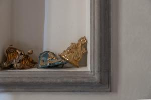 a group of shoes sitting on a shelf in a mirror at Old Bridge large and unique artful apartment with elevator in Florence