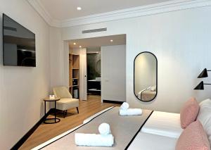 a living room with a bed and a mirror at Soho Boutique Turia in Valencia