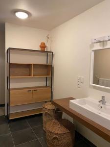 W łazience znajduje się umywalka i lustro. w obiekcie Woning Oostende - Oosteroever NIEUW w Ostendzie