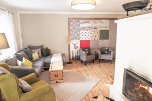 a living room with a couch and a fireplace at Gipfelkönig in Bayrischzell