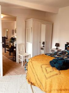 a bedroom with a large bed and a desk at Le Soleil Parisien in Villejuif