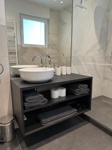 a bathroom with a sink and a mirror at 1-LIVING Apartment Houses in Nuremberg