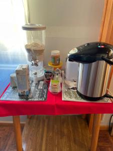 a table with a counter top with a coffee maker and a blender at Posada De Los Gatos in Puerto Natales