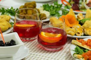 a table with two glasses of juice and plates of food at B&B Spanò in Polistena