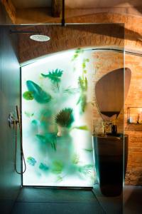 a bathroom with a shower with fish on the wall at World Studio Sibiu in Sibiu