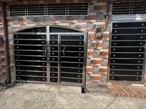 two metal garage doors on a brick wall at Remarkable 3-Bedroom 