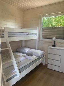 a bedroom with a bunk bed and a window at Biała Mewa Gąski in Gąski