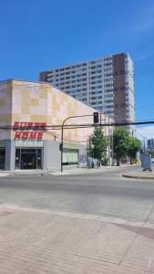 an empty street with a traffic light in front of a building at dpto x día chillan 1411 in Chillán