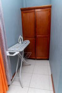 Bougainvillea Apartments في كاستريس: غرفة صغيرة مع طاولة وخزانة