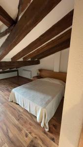 a bedroom with a bed in an attic at Las Tongueras in Pedraza-Segovia