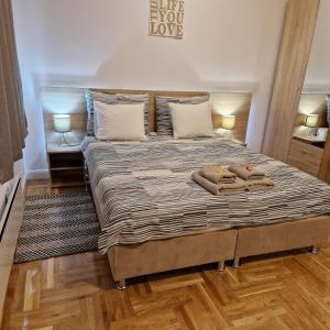 a bedroom with a bed with two towels on it at Apartment Mavero-Free Private Parking in Zagreb