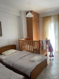 a crib in a bedroom with a child playing at Bright apartment, spacious near the center in Tríkala