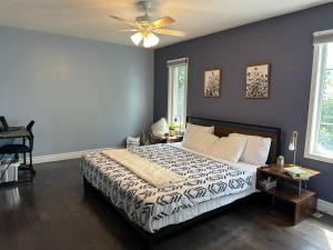 a bedroom with a bed and a ceiling fan at Chic, Spacious Home You'll Love in Markham