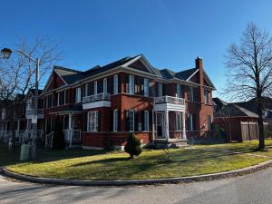 a large red brick house on the corner of a street at Chic, Spacious Home You'll Love in Markham