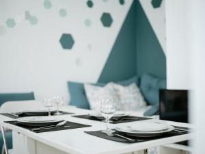 a white table with glasses and plates on it at Hexa Dream in Montévrain +12 photos