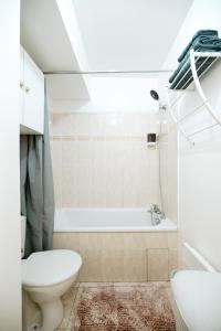 a bathroom with a toilet and a bath tub at Hexa Dream in Montévrain