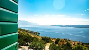 a view of a body of water on a hill at Dalmatian stone villa with heated pool in Lokva Rogoznica