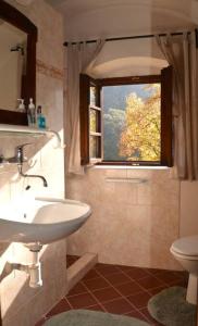 a bathroom with a sink and a window at Vejminek Hynčina 