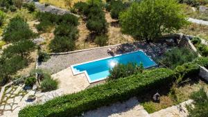 an overhead view of a pool in a garden at Dalmatian stone villa with heated pool in Lokva Rogoznica