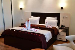 Postel nebo postele na pokoji v ubytování HOTEL IKRAM EL DHAYF