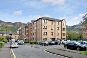 a parking lot with cars parked in front of a building at Edinburgh Apartment near University of Edinburgh - Elforma in Edinburgh