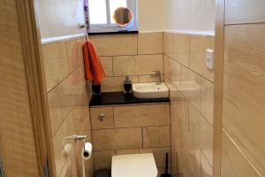 a small bathroom with a sink and a toilet at Stylish and Cosy 3 Bedroom Appartment in London