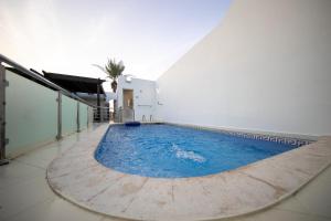 a swimming pool in the middle of a building at Blue Star Villa in Durat Alarous +17 photos