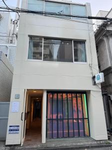 a white building with a bunch of books at waseda house in Tokyo