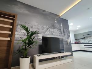 a living room with a tv on a wall at DePiro Point Deluxe - Sliema Holiday Rental in Sliema