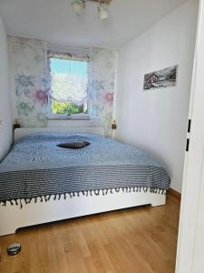 a bedroom with a bed and a window at Seeblick in Daisendorf