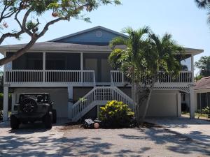 a jeep parked in front of a house at Redfish - Updated & Roomy 1.5 Mi to Beach Full Kitchen W&D in Bonita Springs