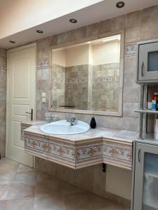 a bathroom with a sink and a mirror at Villa Ariadni in Patra